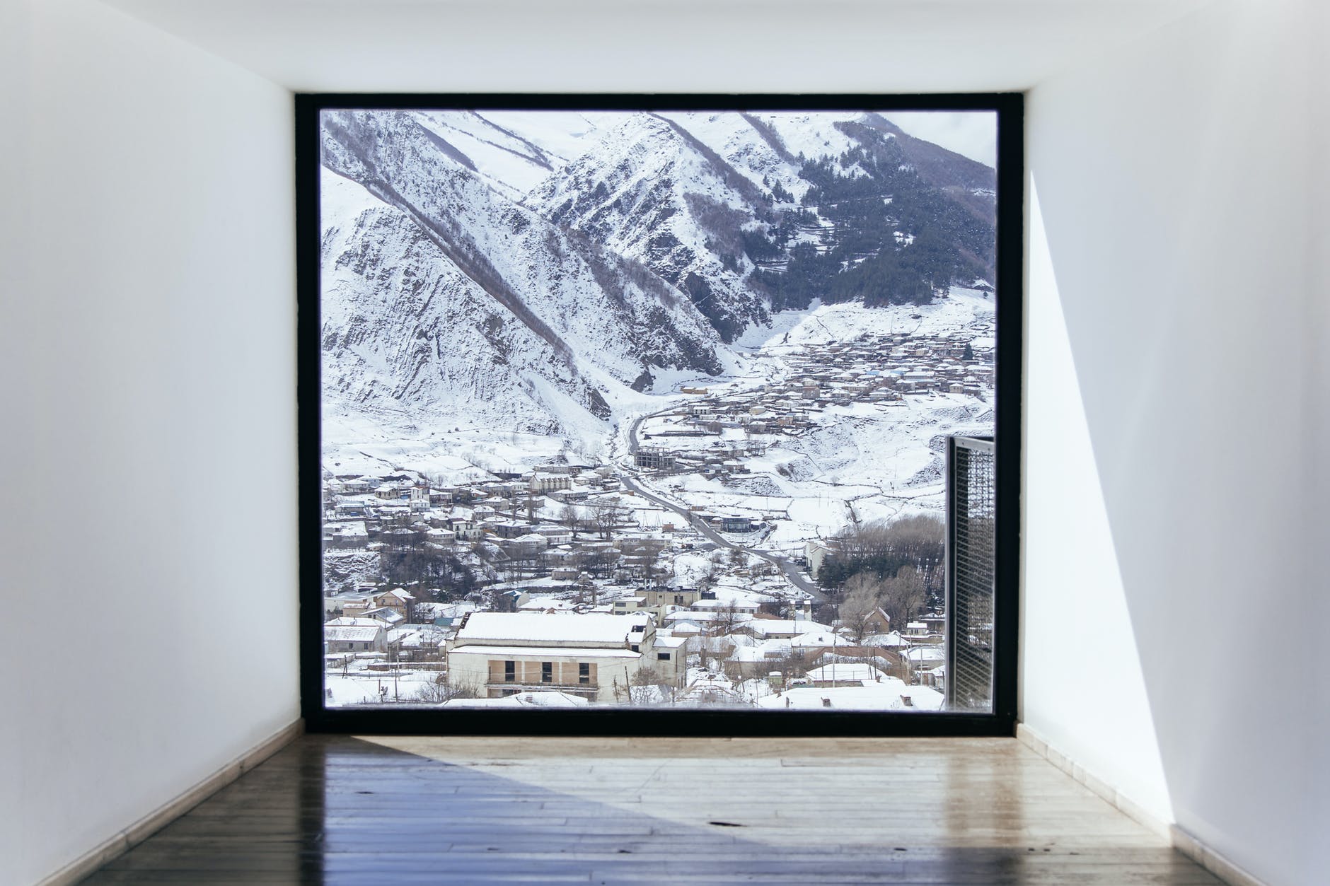 a window overlooking a snow covered town